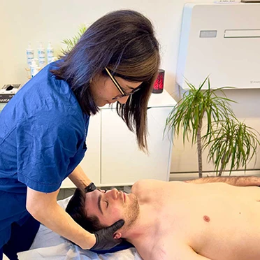 La dottoressa Saviano durante una seduta osteopatica per dolori cervicali Elisa Saviano esegue una palpazione cervicale durante una valutazione osteopatica